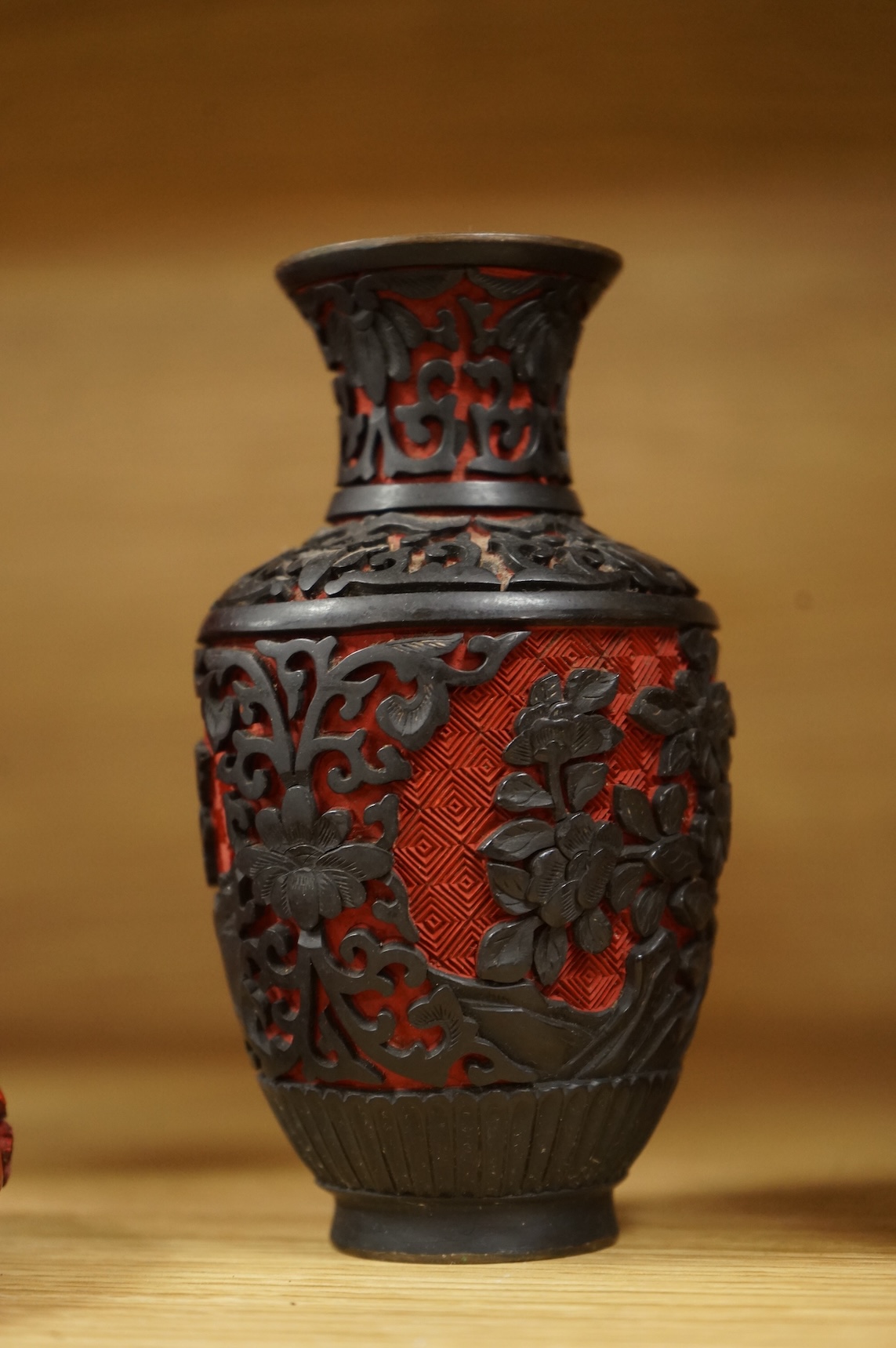 Two Chinese cinnabar lacquer vases and an ashtray, largest 20cm high